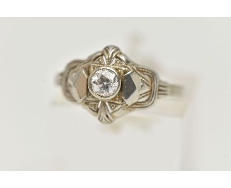 A SINGLE STONE DIAMOND RING, designed as a central old cut diamond within a pierced geometric style surround, estimated diamo
