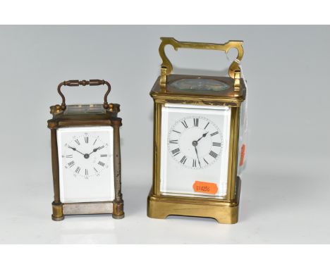 TWO EARLY 20TH CENTURY CARRIAGE CLOCKS, the larger with brass case, white enamel dial with Roman numerals, gong strike, five 