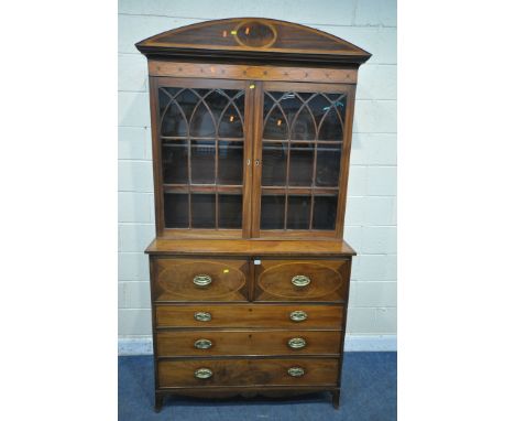 A GEORGIAN MAHOGANY AND CROSSBANDED SECRETAIRE BOOKCASE, the top with a domed top, double astragal glazed doors enclosing thr