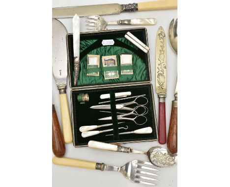 A CASED SEWING KIT AND CUTLERY, the black case with green suede interior, together with button hook, scissors, thimble, pocke