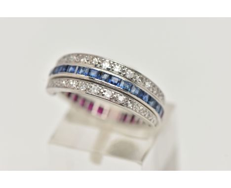 A WHITE METAL 'DAY AND NIGHT' GEM SET RING, designed with a band of half square cut rubies and half square cut blue sapphires