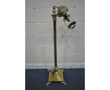 A WARING AND GILLOWS BRASS CORINTHIAN STANDARD LAMP, converted from a paraffin lamp, with foliate detailing, on a square base