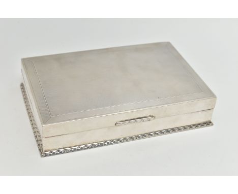 AN EARLY 20TH CENTURY SILVER CIGARETTE BOX, table top box, of a rectangular form, engine turned pattern with textured rim to 