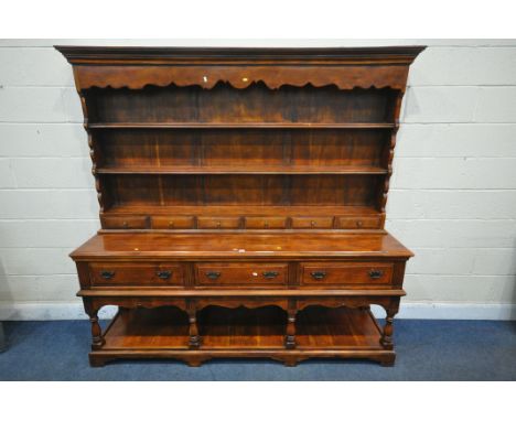 A THEODORE ALEXANDER HARDWOOD DRESSER, the top with a two tier plate rack and six small drawers, the base with three drawers,