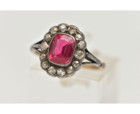 AN EARLY 20TH CENTURY GEM SET RING, designed as a central rectangular ruby within an old cut diamond surround, to the trifurc