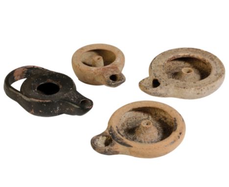 GREEK ATTIC POTTERY OIL LAMP, circa 5th century BC, and three other Greek oil lamps (4). Provenance: The Peter Newall Collect