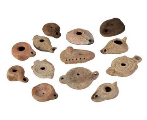 ROMAN POTTERY OIL LAMP, circa 1st/2nd century, moulded with a figure, a Greek Hellenistic terracotta oil lamp with side lug a