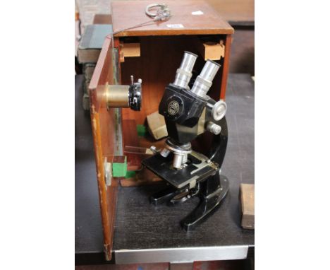 A Baker of London binocular microscope in original wooden case, two boxes of specimen bottles, and a handmade projector.