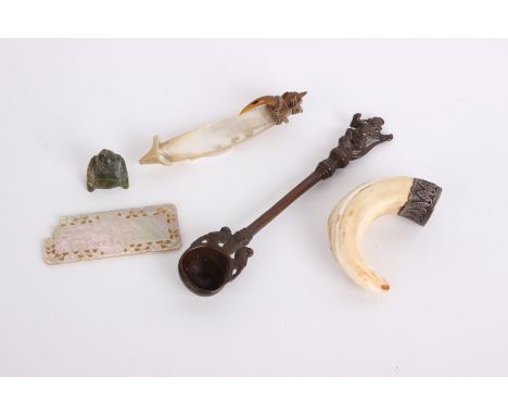 A Solomon Island fish hook, a splintered boar's tooth snuffbox, a copper Indian measuring spoon, a Chinese mother of pearl co