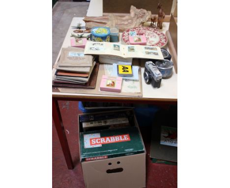 A quantity of cigarette cards, tins, a camera, temperature gauge, a sewing machine, a clock, board games and books