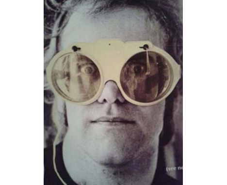 ELTON JOHN CLOTHING - WINDSCREEN WIPER GLASSES. A pair of white plastic sunglasses with 'windscreen wiper' effect and prescri
