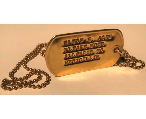 ELTON JOHN 18K GOLD CARTIER DOG TAG. Which reads "ELTON H.JOHN PLEASE NOTE ALLERGIC TO PENICILLIN". Elton had to wear this wh