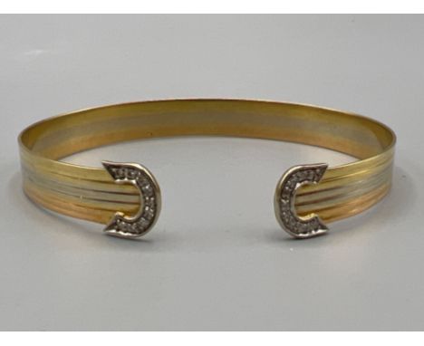 Well presented 18ct 3 tone diamond bangle (12.43g)