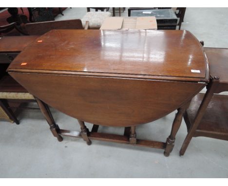 An early to mid 20th Century mahogany gate leg dining table