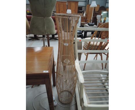 A wicker floor lamp