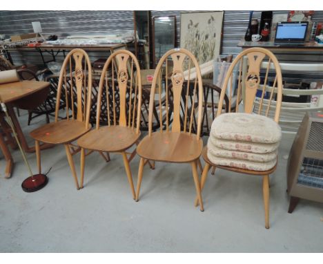 A set of 4 Ercol hoop stick and swan back dining chairs