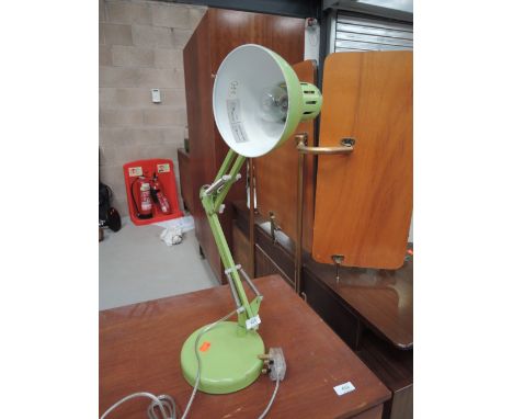An angle poise lamp in green