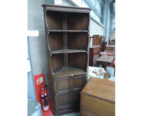 A dark Ercol style corner shelf