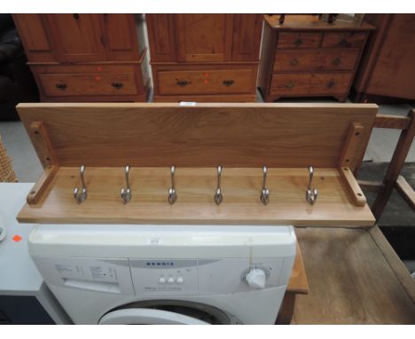 A modern oak wall shelf/coat rack