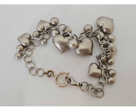A SILVER BRACELET WITH BEAD & HEART MOTIFS
