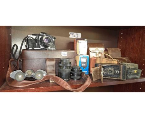 SHELF WITH MISC EMPTY CAMERA CASES & ACCESSORIES, A PRAKTICA MTL3 CAMERA WITH 2 LENSES & A VINTAGE PAIR OF BINOCULARS