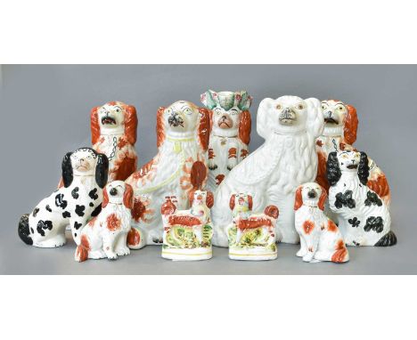 Seventeen Victorian Staffordshire Pottery Spaniels, including begging Spaniel jug, small pair holding game, one with a basket