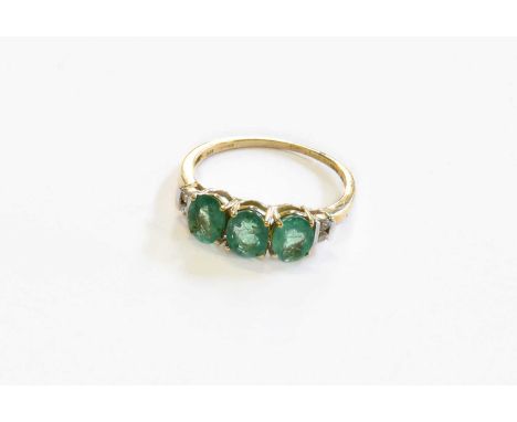 A 9 Carat Gold Emerald and White Stone Ring, finger size N1/2Gross weight 1.9 grams.