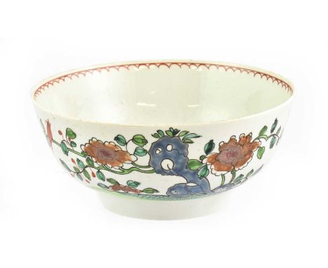 A Christians Liverpool Porcelain Bowl, circa 1770, painted in colours with a bird perched on a branch issuing from rockwork, 