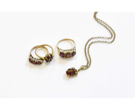 Two 9 Carat Gold Garnet Rings, varying designs and sizes; A Garnet Ring, stamped '9CT'; and A Garnet Pendant on Chain, pendan