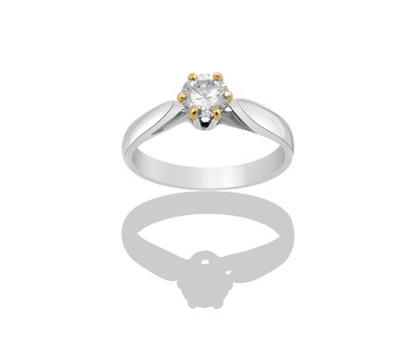 An 18 Carat White Gold Diamond Solitaire Ring, the round brilliant cut diamond in a claw setting, to a tapered shoulder plain