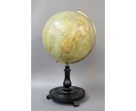 A Philip's 12 inch Terrestrial Globe, turned ebonised plinth, with scroll feet, 56cm high; together with a map of the West In