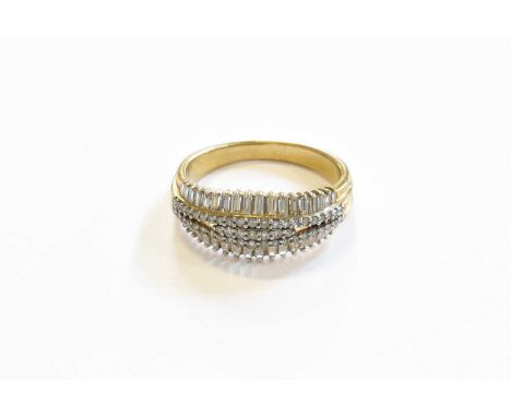 A 9 Carat Gold Diamond Ring, seven graduated eight-cut diamonds flanked by tapering rows of round brilliant and baguette cut 