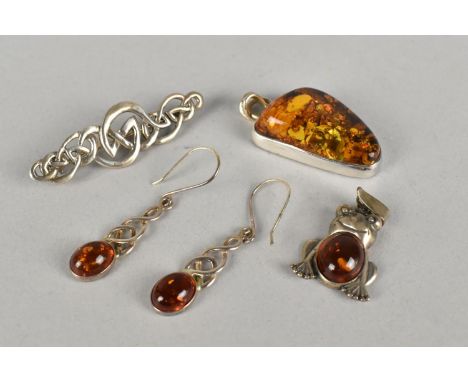 Two Silver Mounted Amber Pendants, Frog and Polished Asymmetric Example, together with a Pair of Amber Mounted Earrings and a