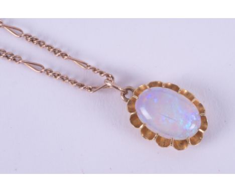 A yellow gold (not hallmarked or tested) antique oval pendant set with a cabochon cut white opal measuring approx. 15mm x 10m