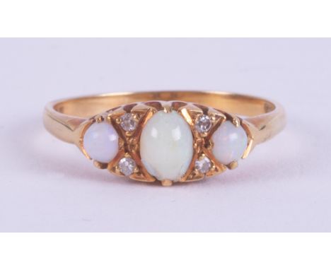 An 18ct yellow gold antique ring set with a central oval cabochon cut opal measuring approx. 55mm x 4mm, with a round cabocho