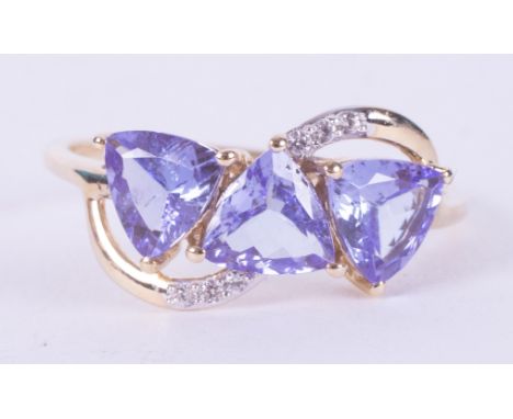 A 9ct yellow gold ring set with three triangular cut tanzanite's, AA quality, 2.10 carats total weight, with 0.06 carats of w