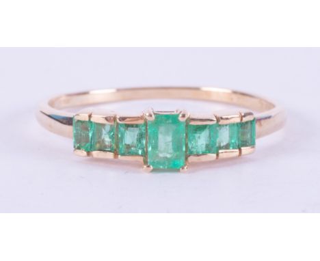 A 9ct yellow gold ring set with seven baguette cut Colombian emeralds, total weight 0.68 carats, 1.57gm, size R 1/2, comes wi