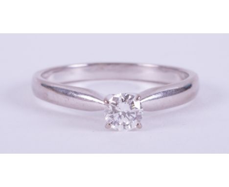 An 18ct white gold four claw ring set with a round brilliant cut diamond, 0.35 carats, colour E &amp; VS2 clarity, no fluores