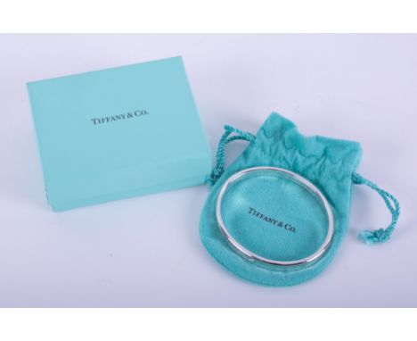 A silver Tiffany &amp; Co oval concave design bangle, stamped inside 1997 Tiffany &amp; Co 925 and on the outside 925 T &amp;