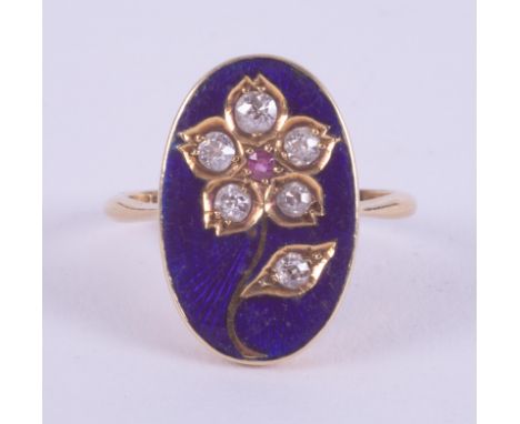 An 18ct yellow gold ring set with a central oval panel with a blue enamel background and a flower design set with approx. 0.3