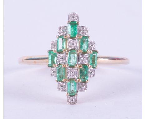 A 9ct yellow gold marquise shaped ring set with 0.39 carats of baguette cut Colombian emeralds interspaced with an illusion s