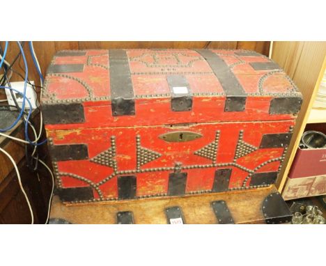 A red painted, brass studded and metal bound dome top trunk, labelled 'W. Webber, Trunk, Packing Case and Candle Box Maker, N