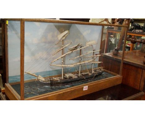 An old painted Cutty Sark diorama, in a glazed oak case, labelled 'by R B Askew', the case 71.5cm wide. 
