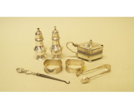 A pair of silver pepperettes, by P G K, Birmingham 1957; together with a pair of silver napkin rings; a silver mustard pot; s