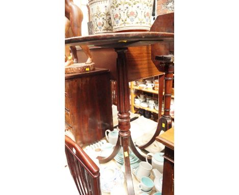 An antique mahogany circular tripod table, with dished top and reeded column, 52.5cm diameter. 