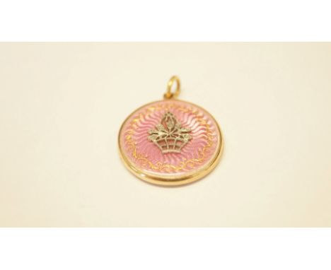 An unmarked pink enamel engine turned locket, having applique diamond decorated basket to the front. Condition Report: Overal