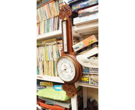 An early 20th century walnut aneroid wheel barometer.