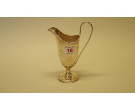 A Georgian style white metal helmet cream jug, unmarked.
