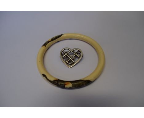 A Georg Jensen silver brooch in heart form with integral anchor; together with an ivory bangle having inked engraved elephant