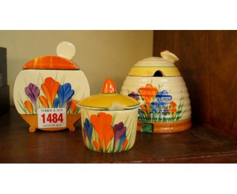 Two Clarice Cliff crocus pattern preserve pots and covers; and a similar mustard pot and cover. Condition Report: THE MUSTARD